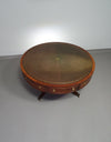 Mahogany Victorian " Heldense " Coffee table / Drum table with leather top on brass wheels. '80s