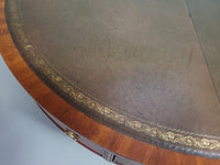 Mahogany Victorian " Heldense " Coffee table / Drum table with leather top on brass wheels. '80s