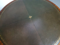 Mahogany Victorian " Heldense " Coffee table / Drum table with leather top on brass wheels. '80s