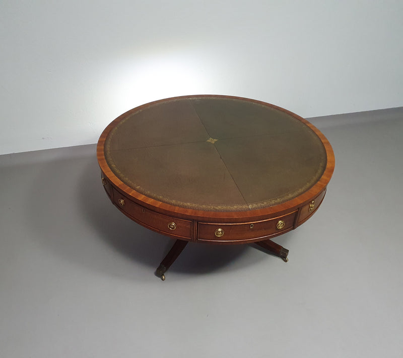 Mahogany Victorian " Heldense " Coffee table / Drum table with leather top on brass wheels. '80s