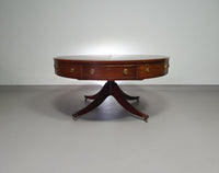 Mahogany Victorian " Heldense " Coffee table / Drum table with leather top on brass wheels. '80s