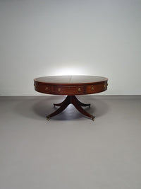 Mahogany Victorian " Heldense " Coffee table / Drum table with leather top on brass wheels. '80s