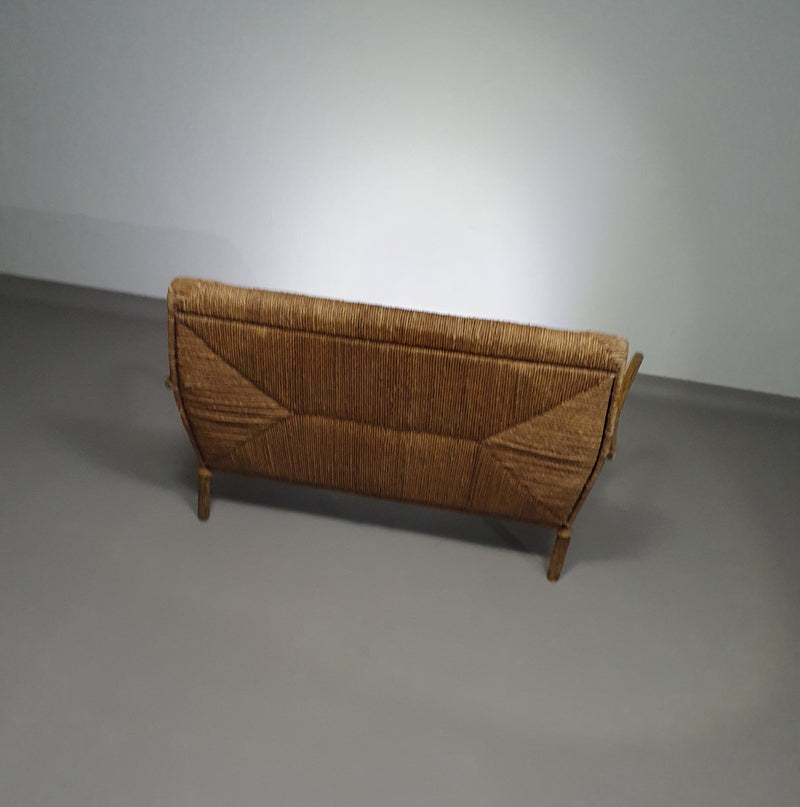 Vintage French papercord sofa with a metal frame base