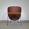 Small side table / chair with elegantly curved wrought iron legs enhanced by a woven rattan seat and top