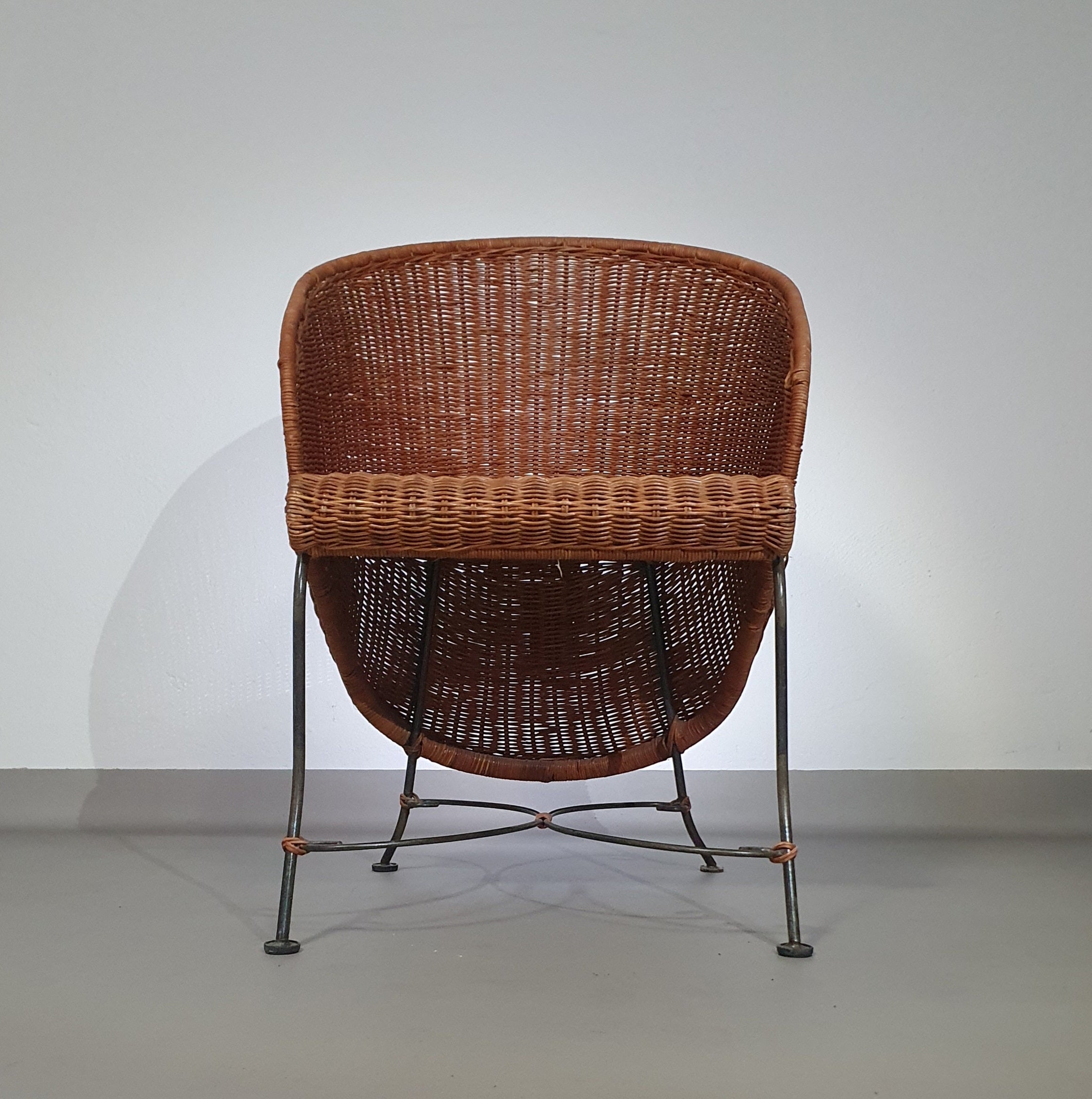 Small side table / chair with elegantly curved wrought iron legs enhanced by a woven rattan seat and top