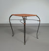 Small side table / chair with elegantly curved wrought iron legs enhanced by a woven rattan seat and top