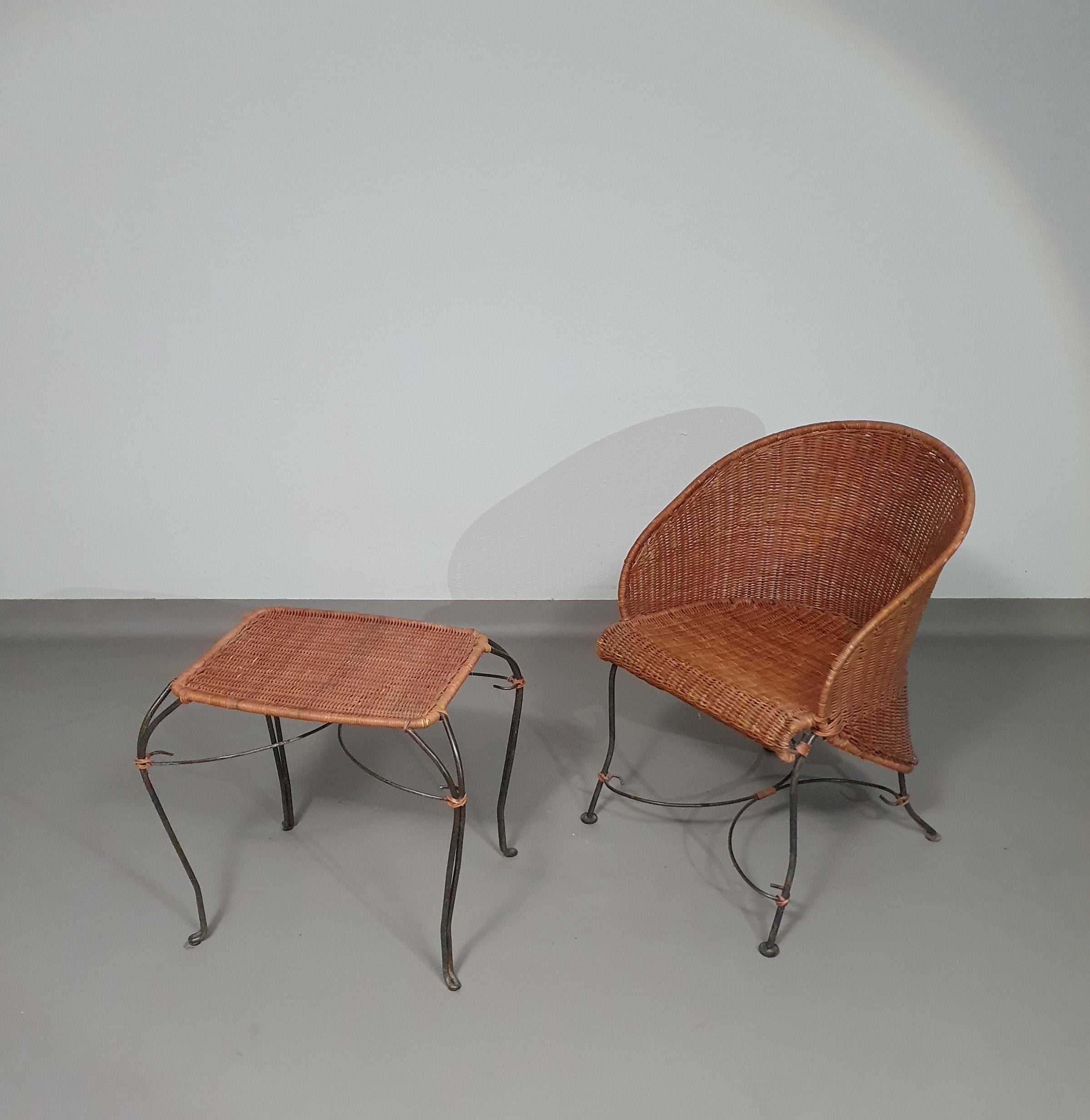 Small side table / chair with elegantly curved wrought iron legs enhanced by a woven rattan seat and top