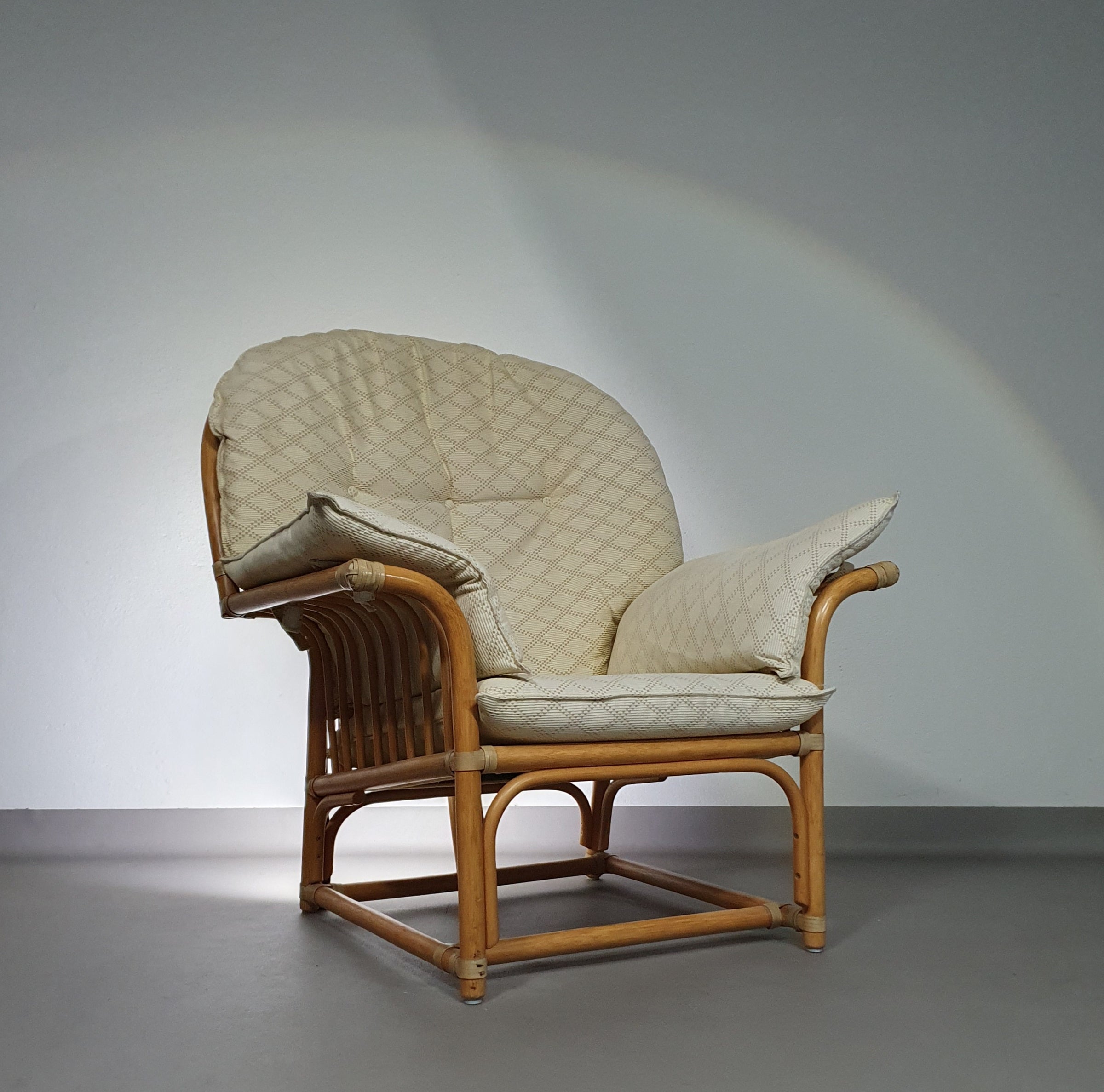 Oversized rattan / bamboo lounge chair with original cushions. 1970s