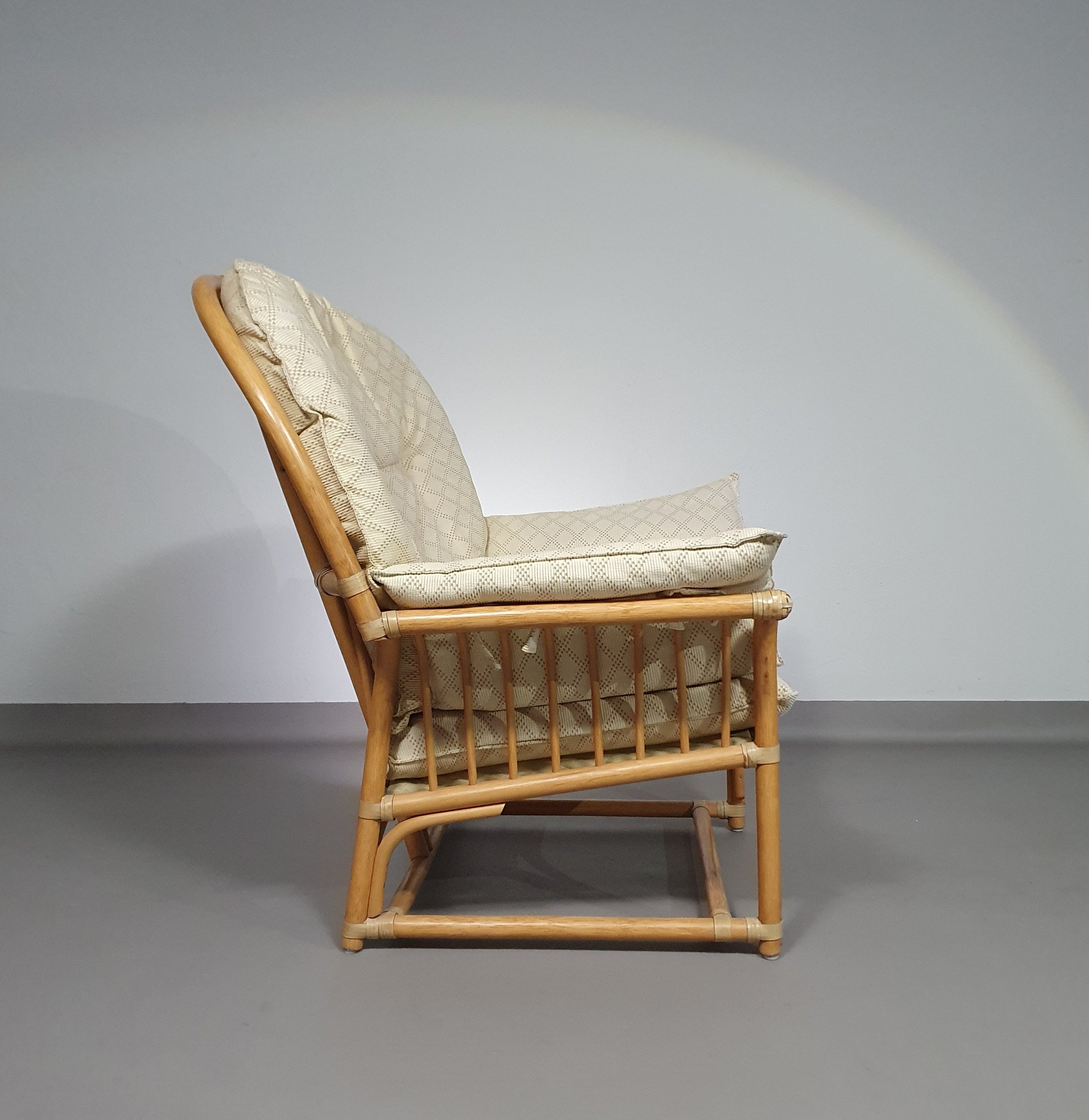 Oversized rattan / bamboo lounge chair with original cushions. 1970s