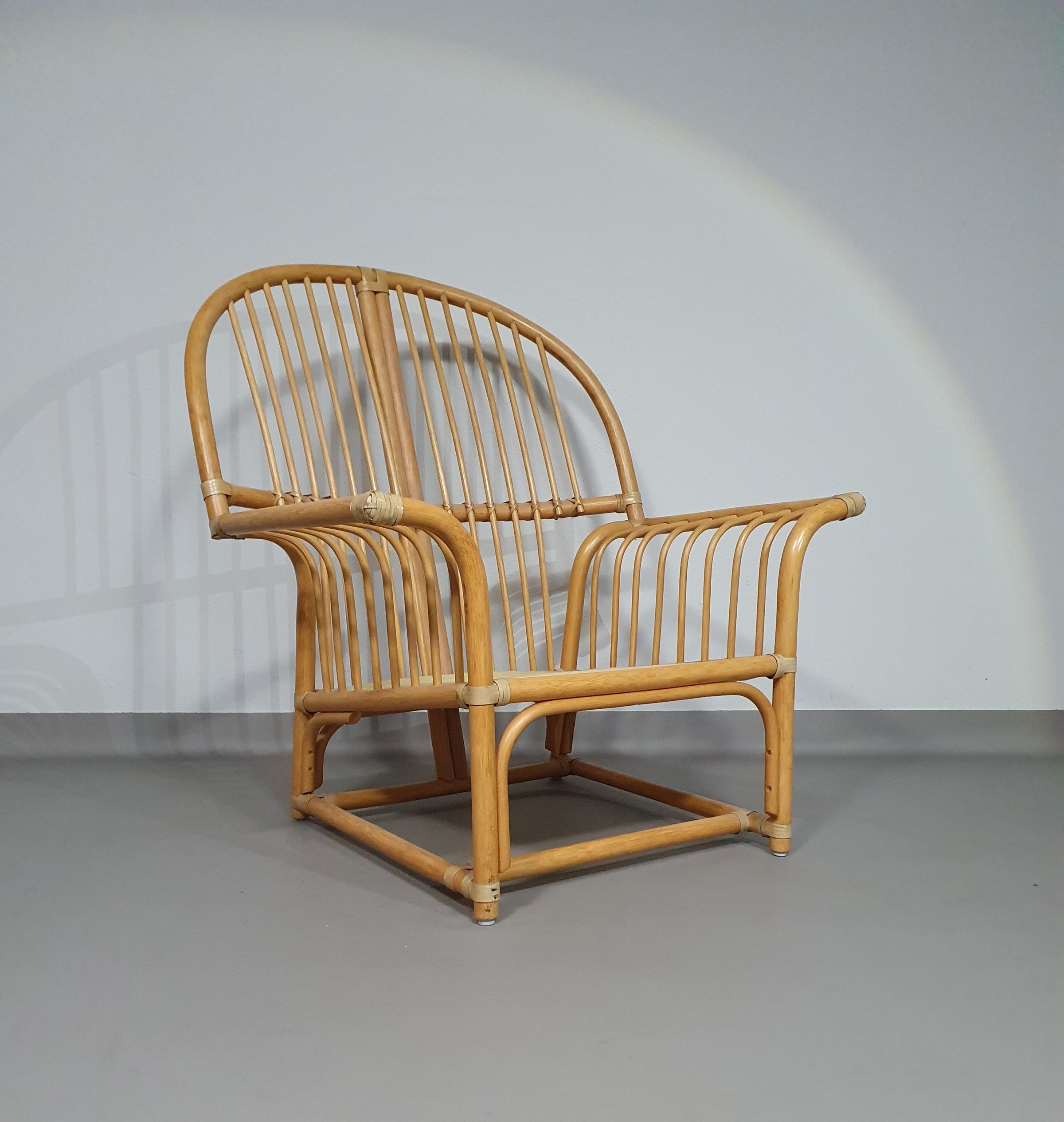 Oversized rattan / bamboo lounge chair with original cushions. 1970s