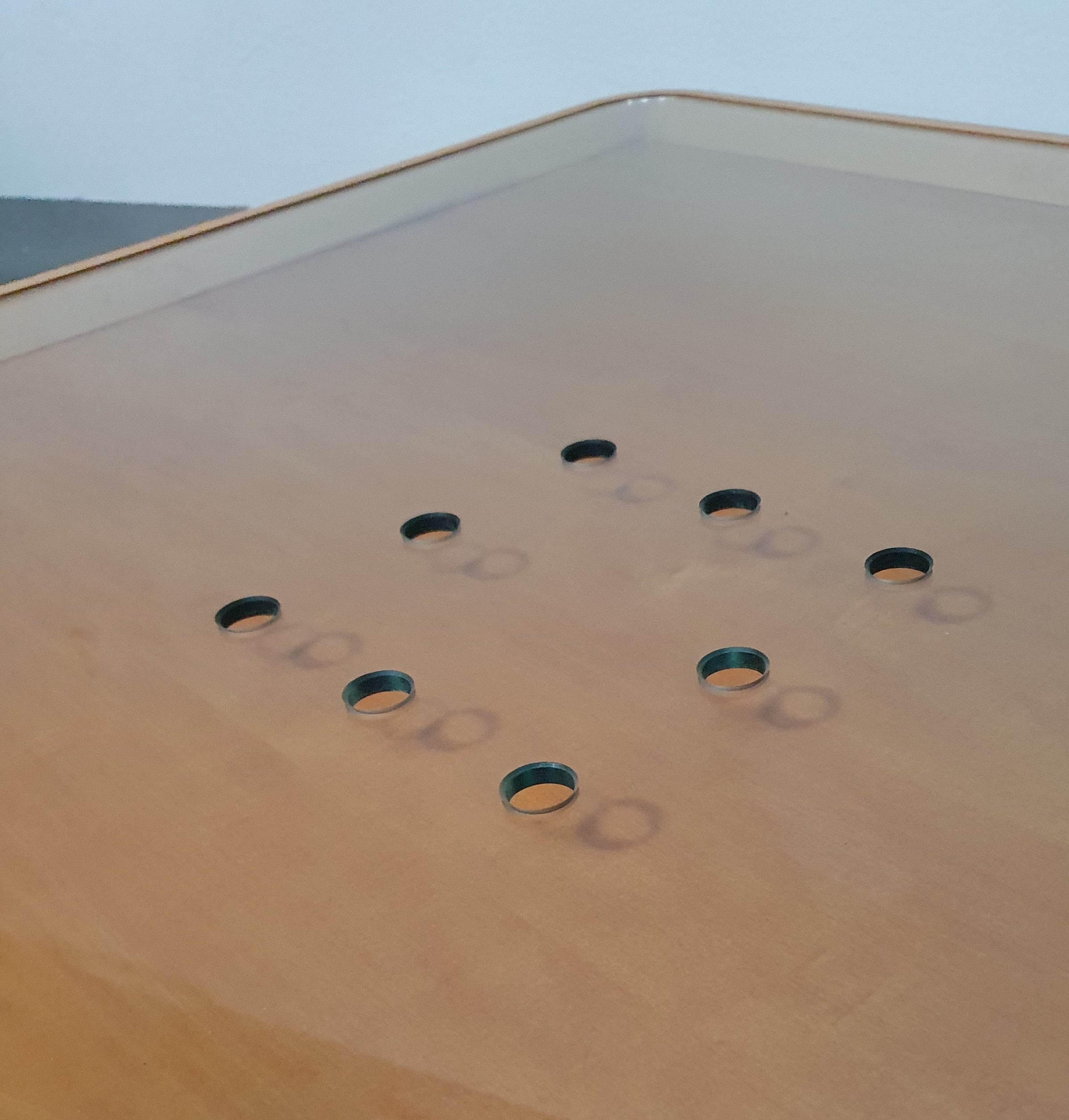 Rare coffee table 110 x 110 x height 35 cm
with 8 flange wooden / cork caps in the glass top.