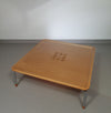 Rare coffee table 110 x 110 x height 35 cm
with 8 flange wooden / cork caps in the glass top.