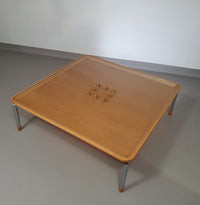 Rare coffee table 110 x 110 x height 35 cm
with 8 flange wooden / cork caps in the glass top.