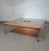 Rare coffee table 110 x 110 x height 35 cm
with 8 flange wooden / cork caps in the glass top.