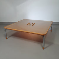 Rare coffee table 110 x 110 x height 35 cm
with 8 flange wooden / cork caps in the glass top.