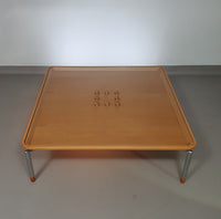 Rare coffee table 110 x 110 x height 35 cm
with 8 flange wooden / cork caps in the glass top.