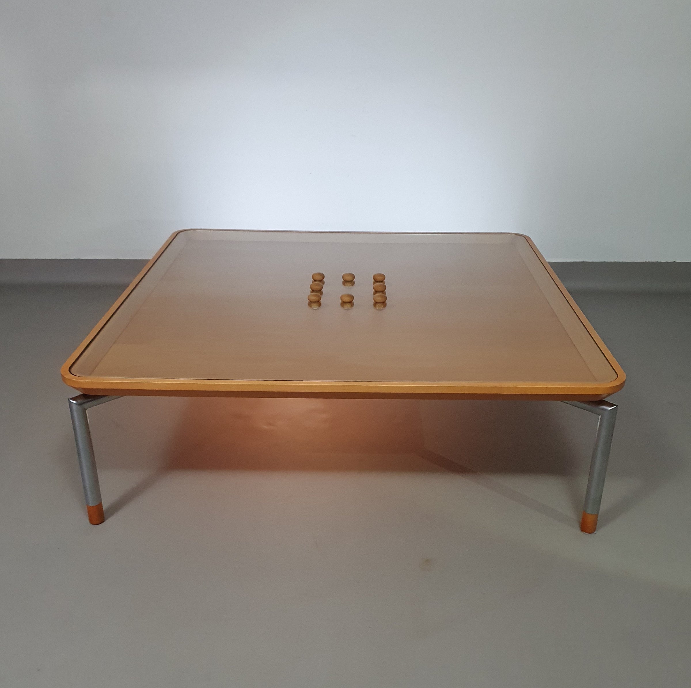 Rare coffee table 110 x 110 x height 35 cm
with 8 flange wooden / cork caps in the glass top.