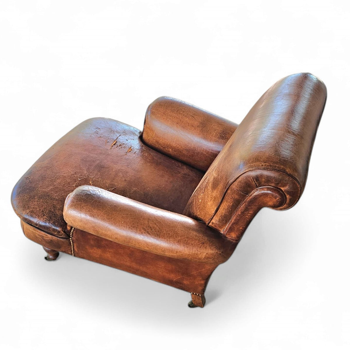 Beautiful and stately old English sheep leather club chair with armrests