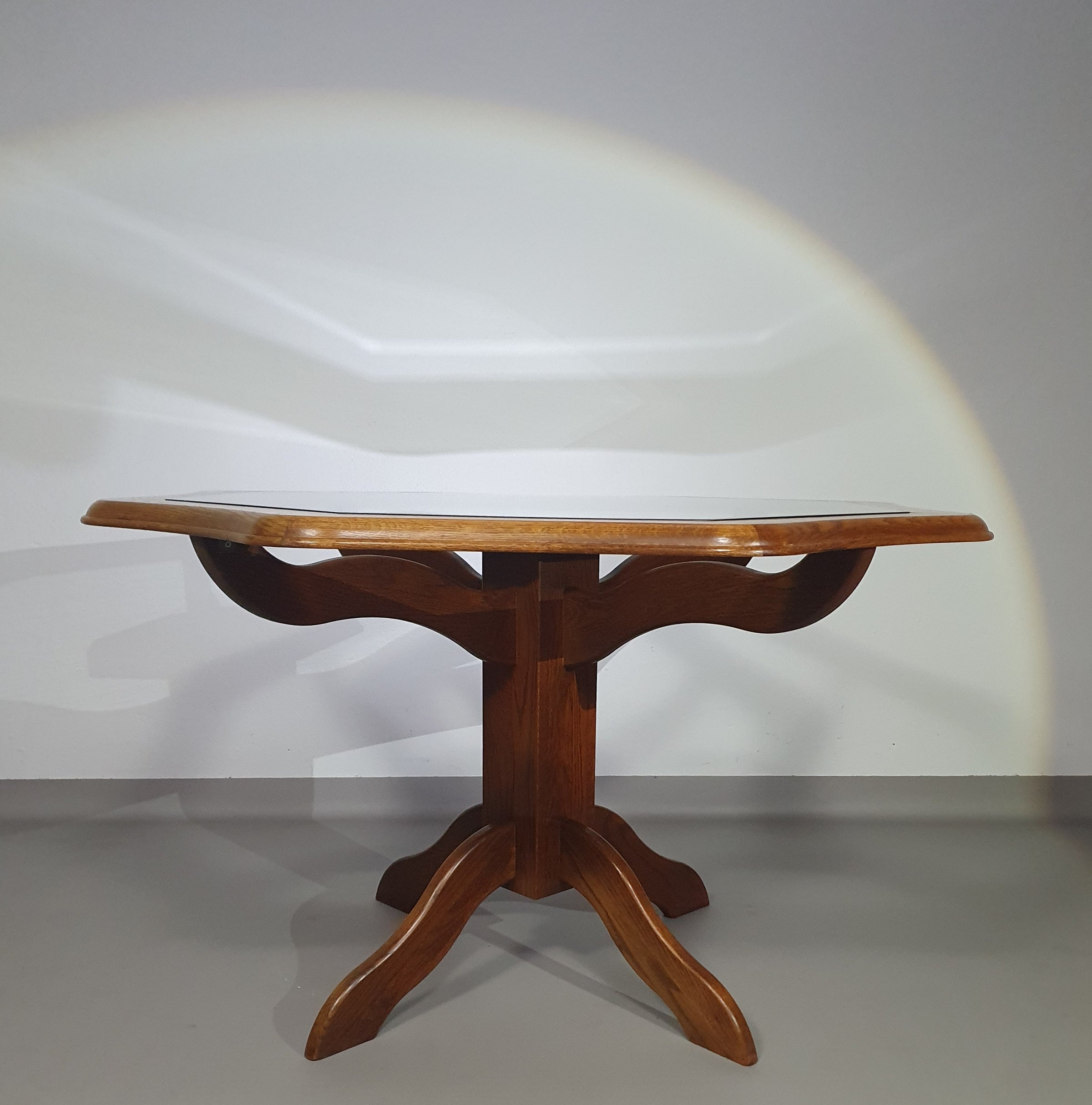 Octagonal oak dining table with inlaid glass top