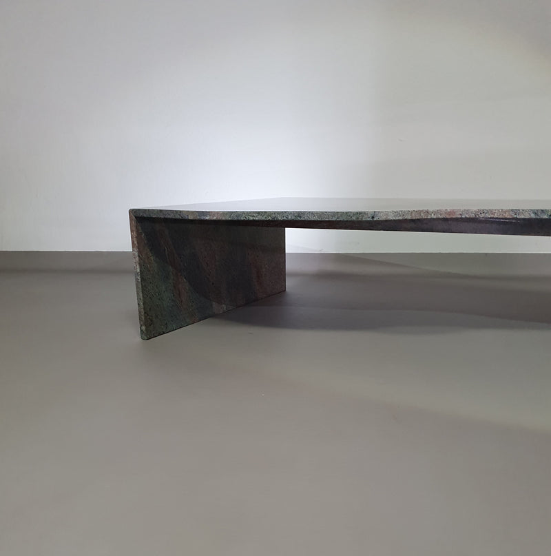 A free form large granite coffee table with three straight lines contrasting to a wavy front. 1970s