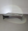 A free form large granite coffee table with three straight lines contrasting to a wavy front. 1970s