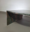 A free form large granite coffee table with three straight lines contrasting to a wavy front. 1970s