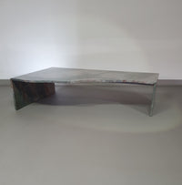 A free form large granite coffee table with three straight lines contrasting to a wavy front. 1970s