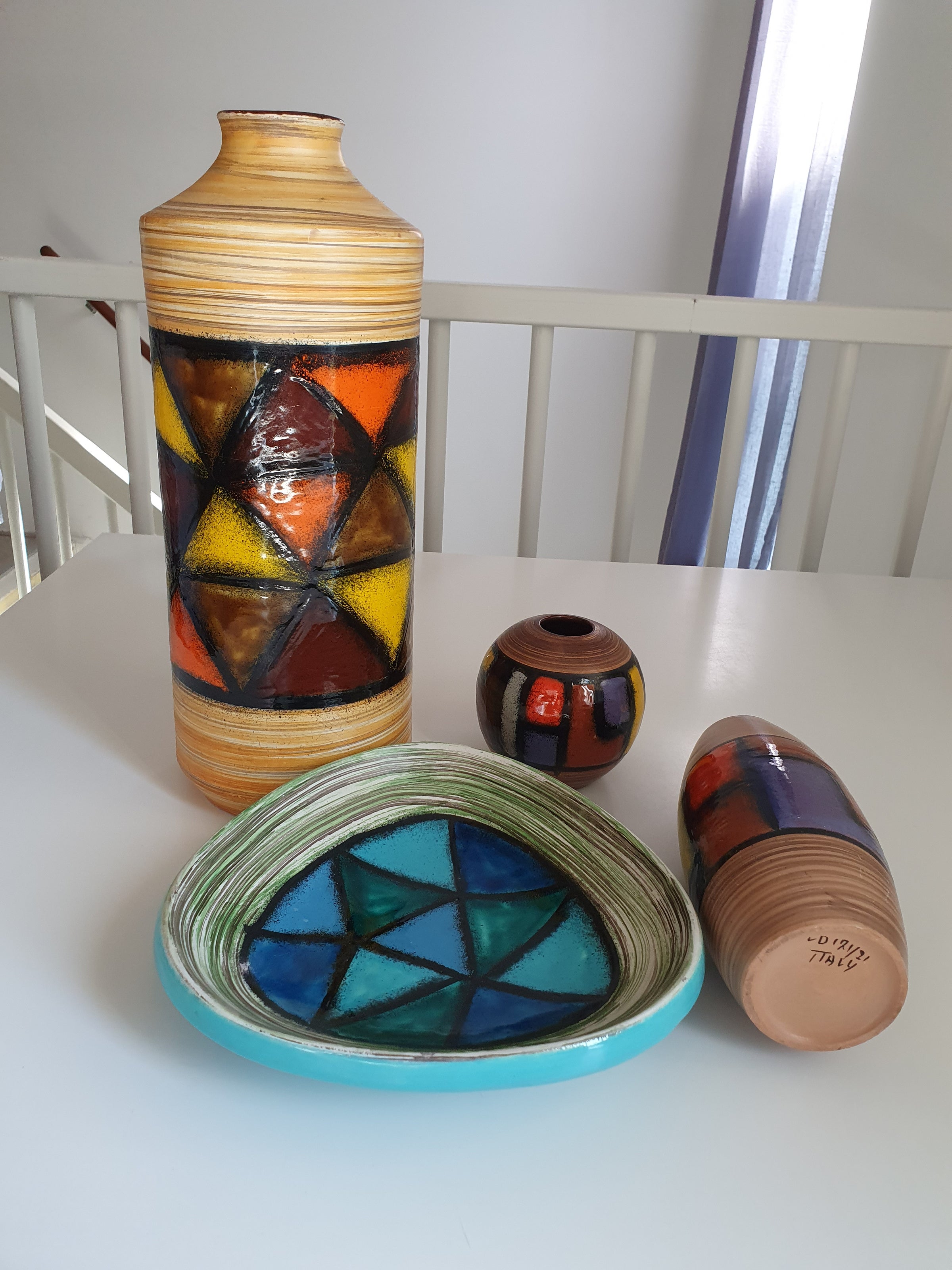 Mid-century pattern Vetrata vases and bowls by Aldo Londi for Bitossi Italy. Black, blue, orange and yellow on a brushed background.