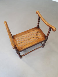 Wokkel chair with armrests and webbing seat.